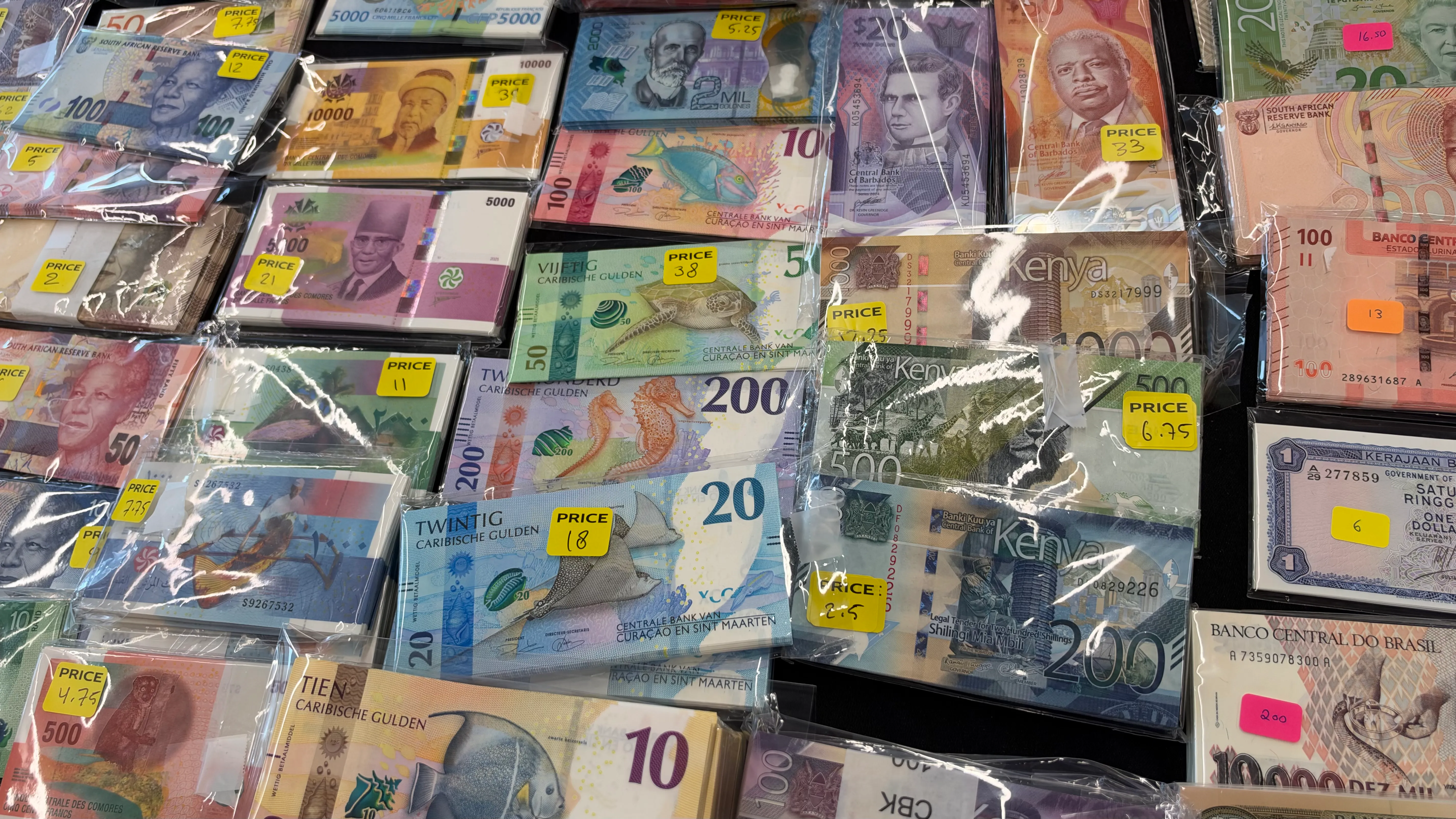 Bundles of banknotes in plastic sleeves with yellow price labels