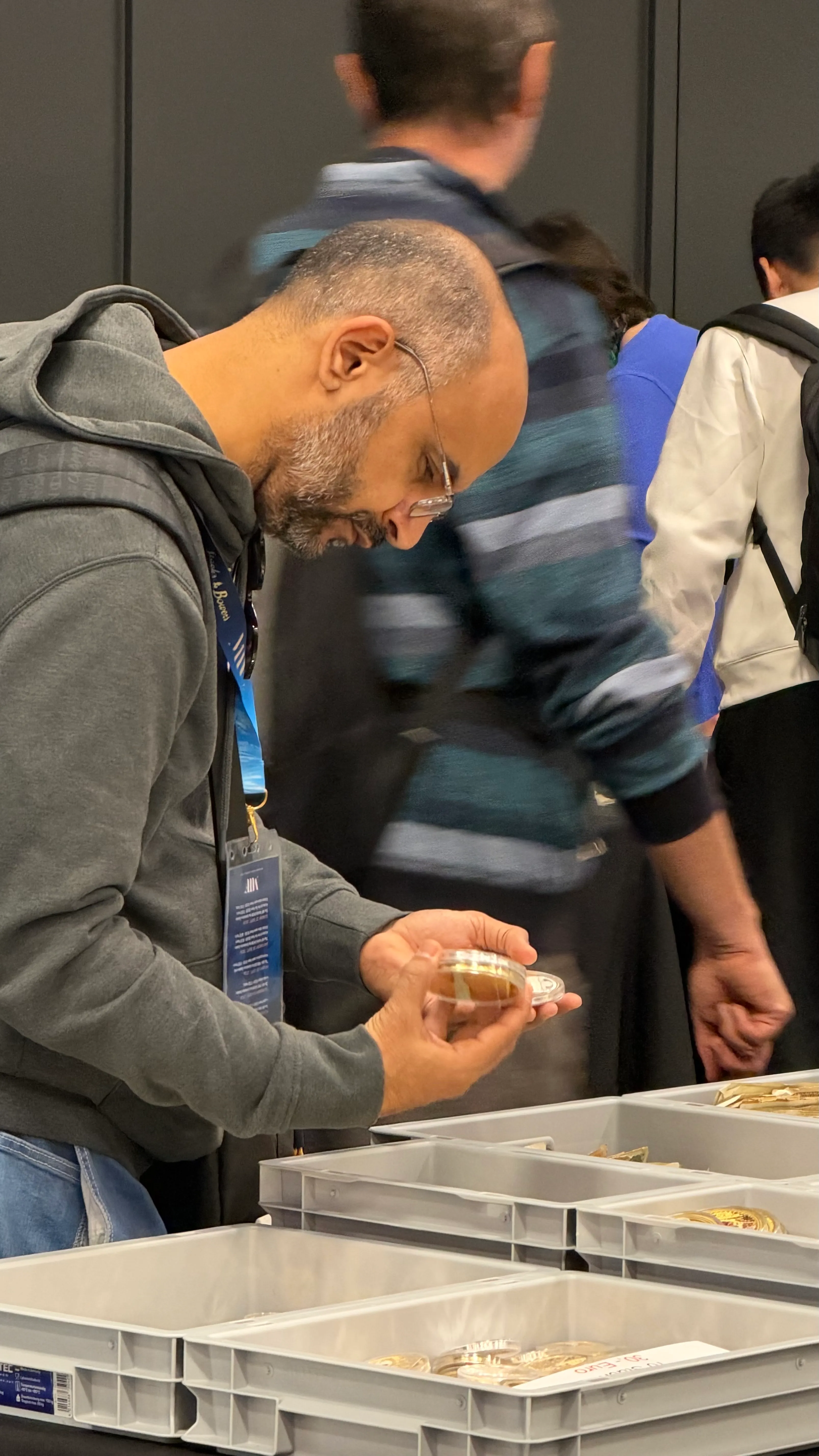 Visitor examining a gold coin in a capsule