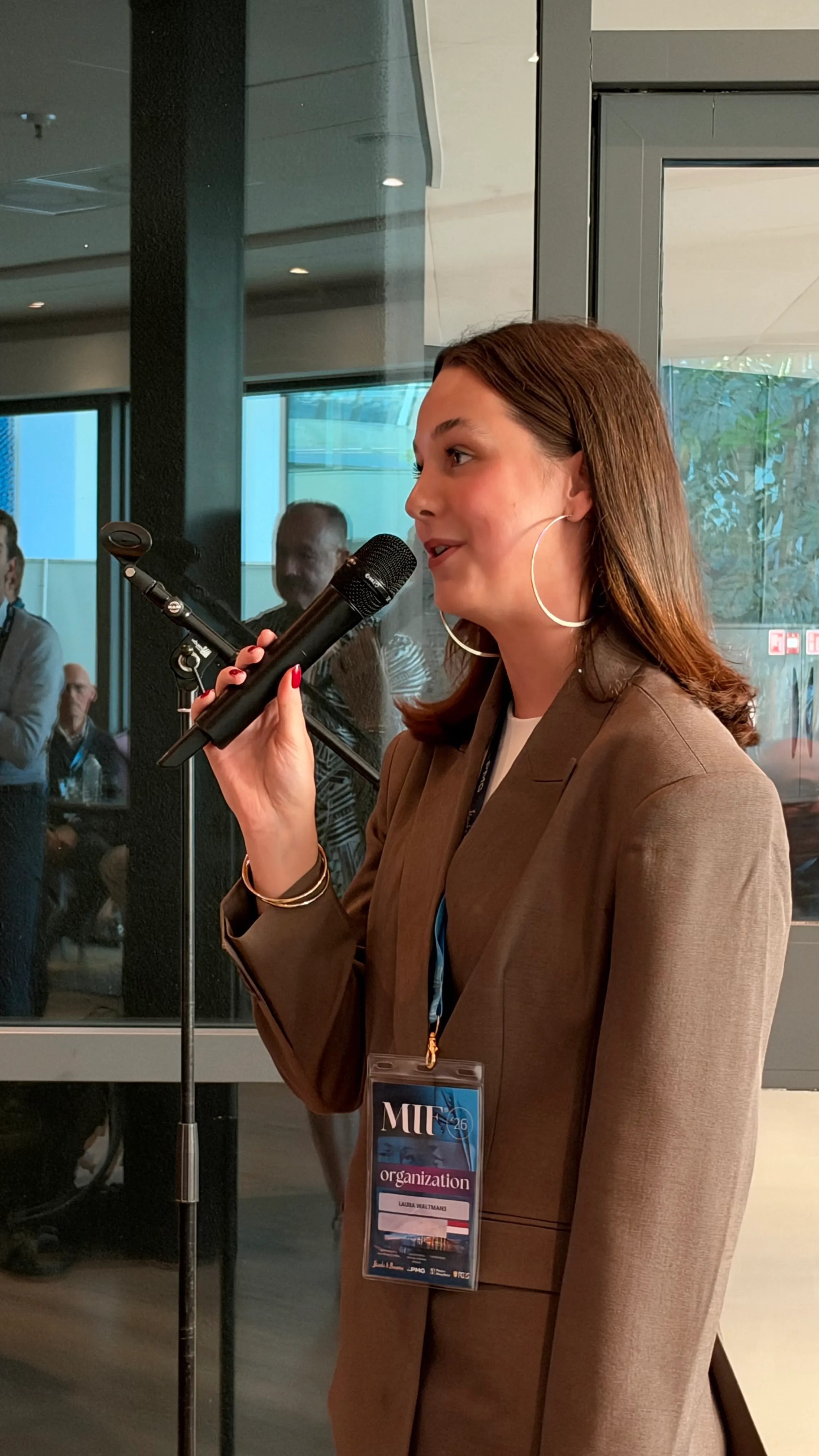 Member of the organization speaking into a microphone