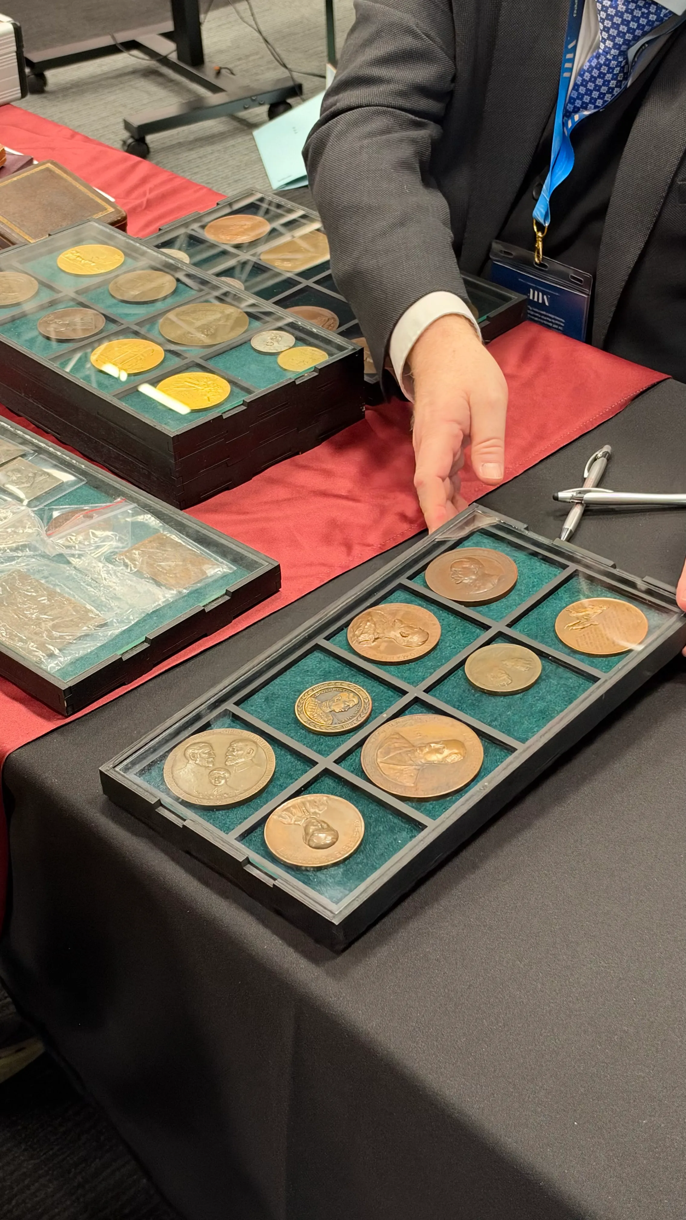 Bronze and gold medals in glass-topped display trays